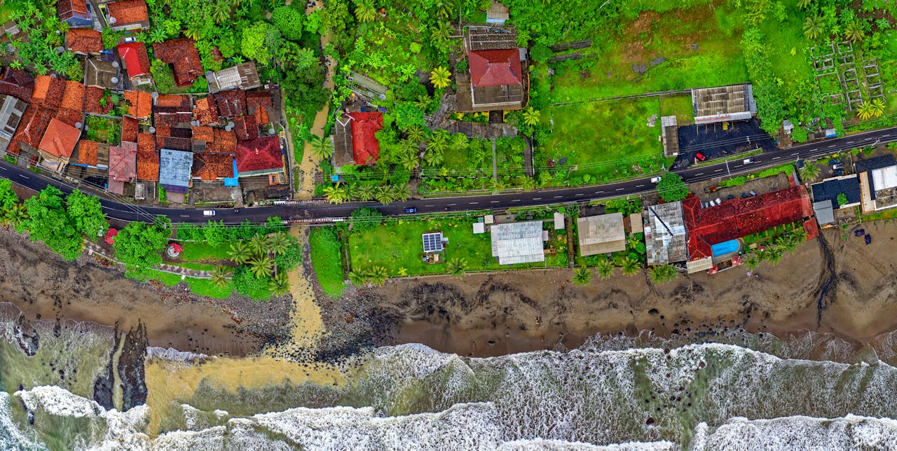 Vibrant aerial view of Cisolok, West Java, showcasing coastline and colorful houses.